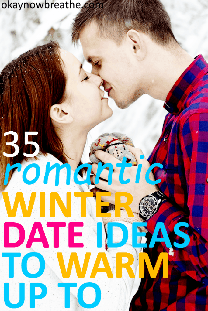 Couple kisses in the snow with hand touching. Text overlay says 35 romantic winter date ideas to warm up to