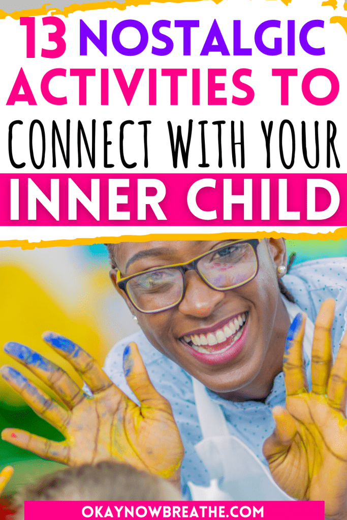 A Black woman with glasses is smiling at the camera with both palms out and facing the camera. She has yellow and blue finger paint on her palms. Text overlay says, "13 nostalgic activities to connect with your inner child - okaynowbreathe.com"