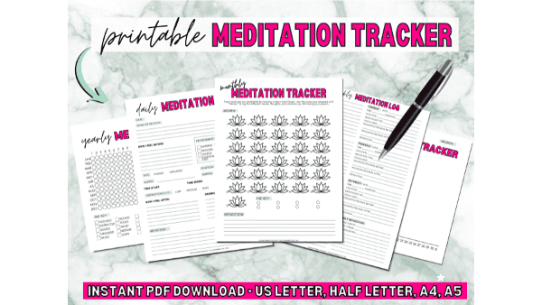 A mockup of meditation tracker worksheets layed out on a green marble background.