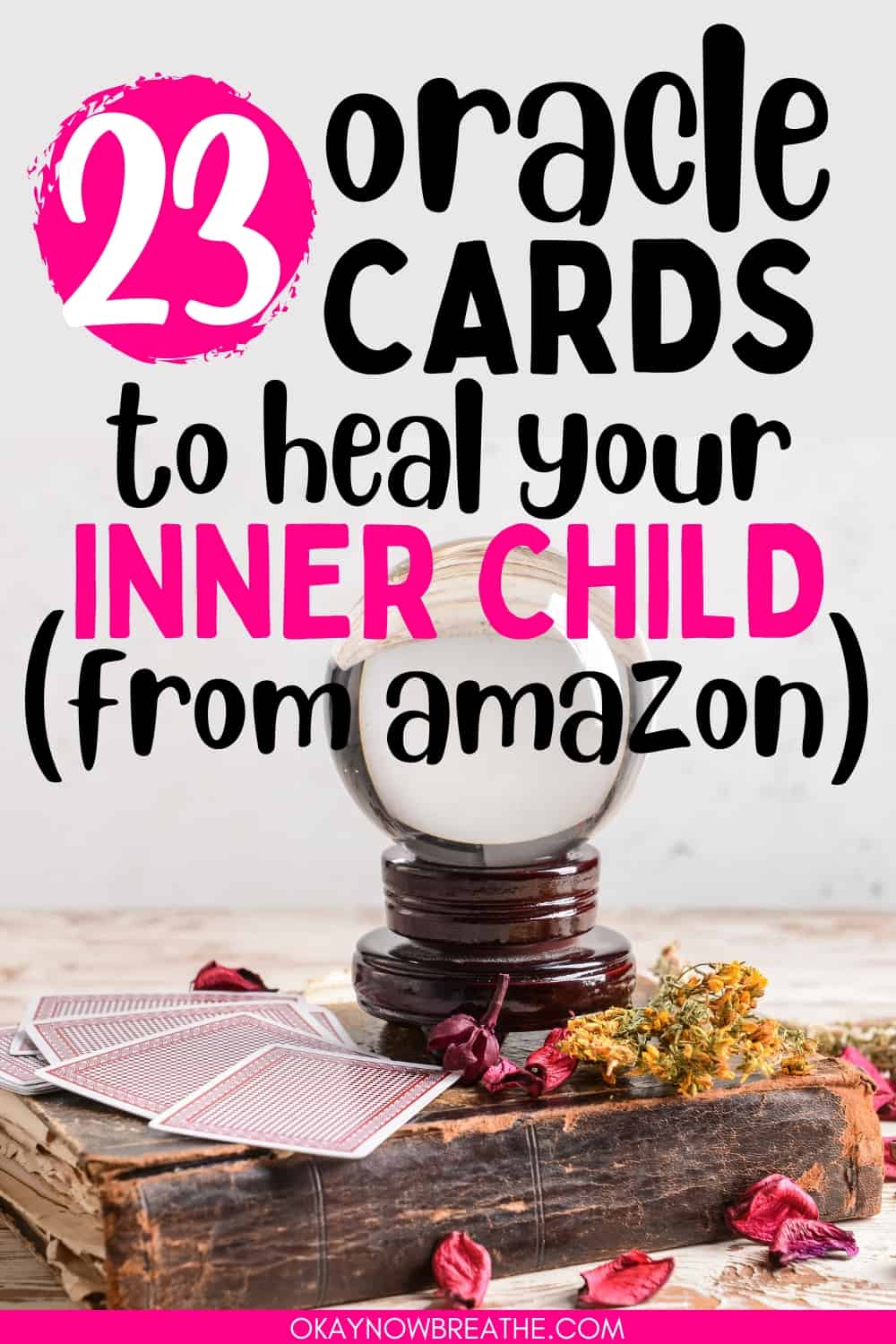 There is a distressed book with dried flower petals sprawled about. There are some spread out cards, as well as a crystal ball on top of it. There is a text overlay that says: 23 oracle cards to heal your inner child (from amazon)