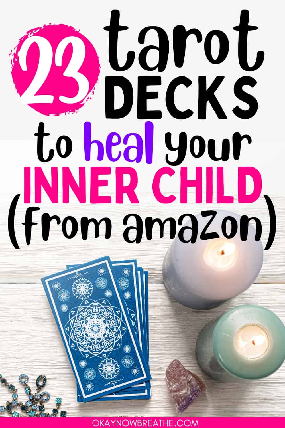 There are two lit candles and a crystal on the right. Next to them on the left, there are tarot cards faced down. There is text overlay on this image that says: 23 tarot decks to heal your inner child (from amazon) - okaynowbreathe.com