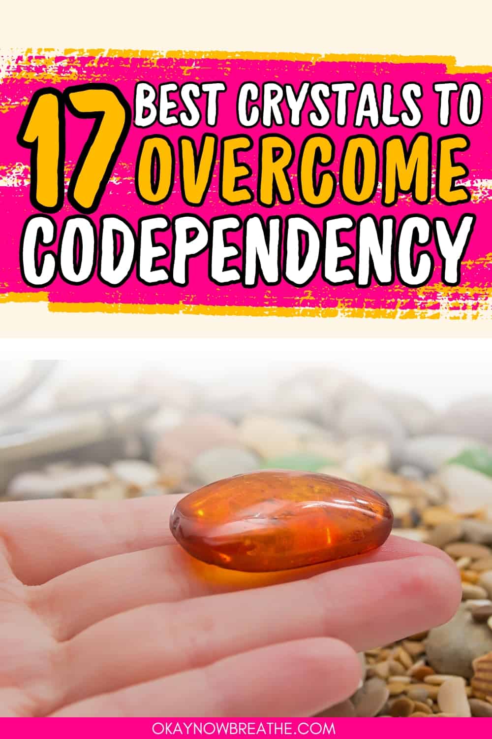 There is a palm folding a red crystal towards the fingers. Above, there is text that says, "17 best crystals to overcome codependency"
